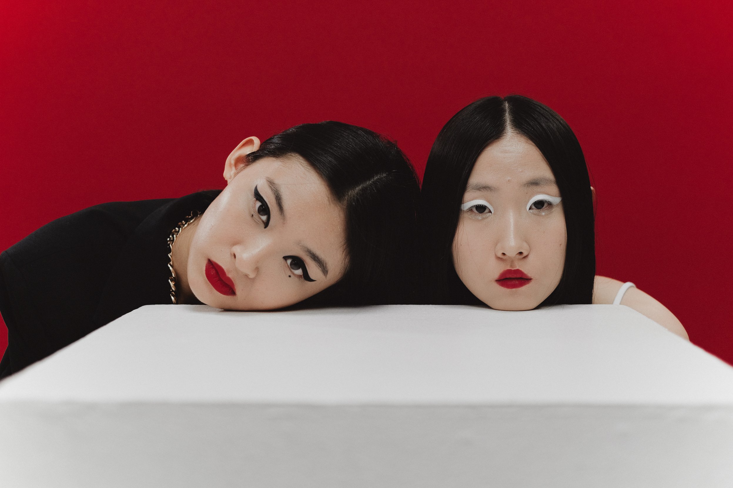 Women Lying on White Table